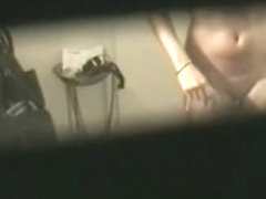 Busty brunette filmed naked by a window voyeur