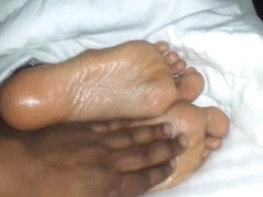 Oiled wifes foot filmed up close
