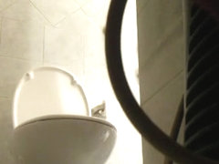 Pissing girl gets caught on a hidden cam in the bathroom