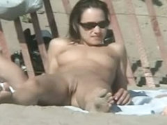 Tempting women sunbathing in a nude beach video