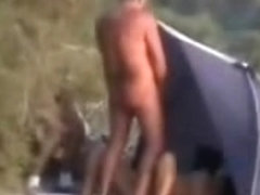 Mature bitch masturbates for voyeurs at nude beach