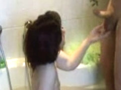 Redhead gives blowjob in a bathtub
