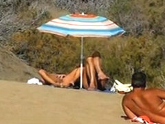 Slutwife masturbating for pervs in a beach