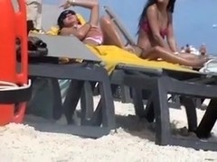 Pretty brunette smokes a cig on a nude beach in hidden cam clip
