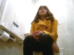 Asian women taking a leak in public toilet
