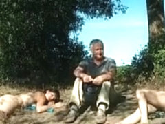 Old daddy sits with young hotties on the beach