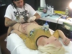 Blonde bimbo moans with pain as her pubis was being tattooed