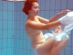 Cute redhead plays naked underwater