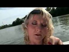 Monik rubs her aged pussy on the boat in this video.