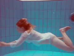 Cute redhead plays naked underwater