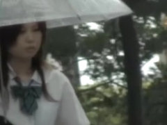 Asian schoolgirl gets street sharking on a rainy day.