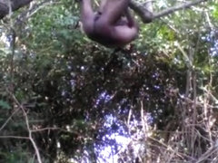 Village boy nude in forest and play with tree