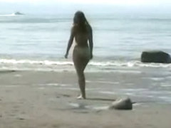 A naked blonde and a golden haired beauty in a beach porno vid