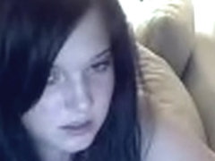 Woman masturbates with large toy.