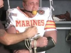 Tall redheaded football player bound gagged and stripped.