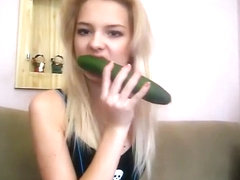 Teen beauty plays with a cucumber