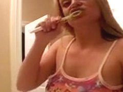 Slutty blonde Denise brushes her teeth and flashes her boobs