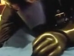 Rubber doggie servicing a coverall chap