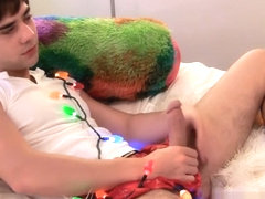 Twink tied with christmas lights wanks his big dick solo