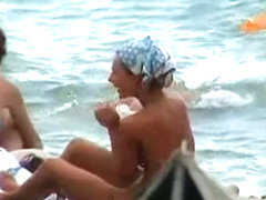 Buxom nude beach babes flaunt their jugs before a hidden camera
