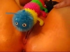 Pussy toying with a caterpillar