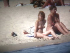 Buxom blonde filmed on a nudist beach