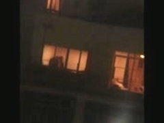 Chick undressing in window voyeur video clip
