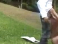 Blonde shemale fucks guy doggy style in a park