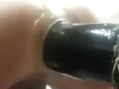 A kneeling giant dildo fucking