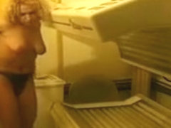Busty Czech girl strips naked and fingers her puffy clit in a solarium