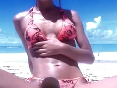Bikini cutie plays with a dildo during beach webcam show