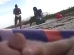 Horny daddy pisses and jerks off his penis on a black babe at the beach