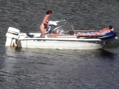 Nudist couple has fun in the middle of a beautiful lake