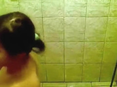 Voyeur tapes a ponytailed brunette taking a shower