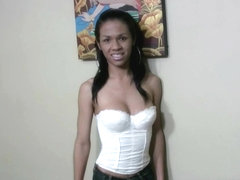 Dark skin ladyboy in jeans and corset makes her nipples wet