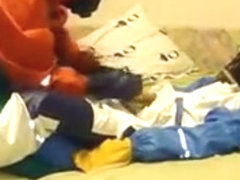 Raingear buddies play on ottoman