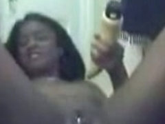 Ebony girl masturbating with a dildo