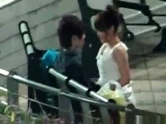 Voyeur tapes an asian girl couple having sex on a bench in the park