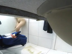 Woman takes off her clothes in bathroom
