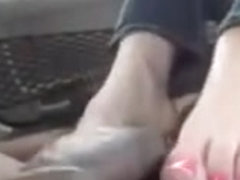 Sexy blonde girl give footjob in the car